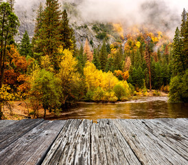 Naklejka na ściany i meble Yosemite National Park Valley and Merced River at autumn. Low clouds lay in the valley. California, USA.