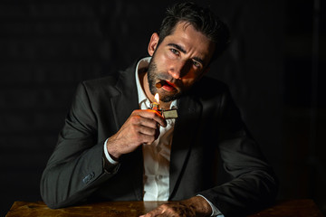 business man in suit, smokes a cigar.
