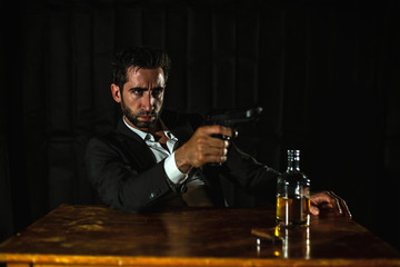 Man with a gun and whiskey.