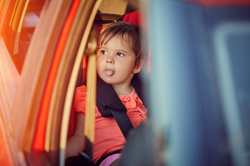 Adorable baby in safety car seat.