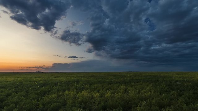 Storm clouds rolling over prairies at sunset 4K time lapse