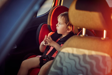 Adorable baby in safety car seat.