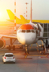 Passenger plane in the airport at sunrise. Aircraft maintenance.