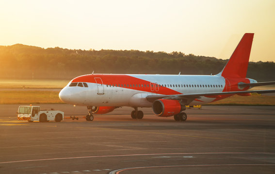 TUG Pushback tractor with Aircraft on the runway in airport.