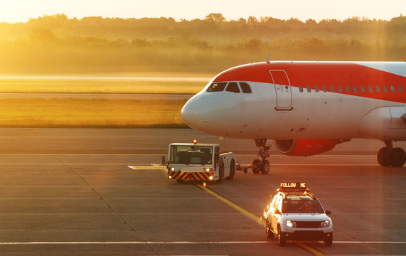 TUG Pushback tractor with Aircraft on the runway in airport.
