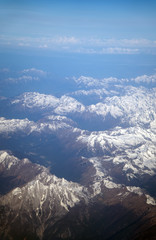 Fototapeta premium Aerial view of the mountains in the clouds.