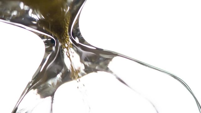 Golden Seconds Flowing Out. Golden Sand is poured into the lower part of the hourglass with a thin trickle that is brightly lit by backlight. Filmed at a speed of 120fps