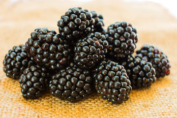 Fresh blackberry berries on the table, closeup.