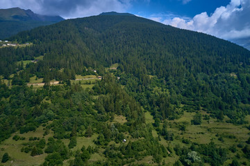 Fototapeta na wymiar Panoramic view of the Ponte di Legno region of Trento the north of Italy. The popular ski resort town of Ponte di Legno. Summer time of the year. Aerial view. Photo taken on a drone.