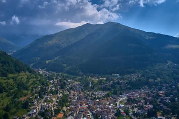 Fototapeta premium Panoramic view of the Ponte di Legno region of Trento the north of Italy. The popular ski resort town of Ponte di Legno. Summer time of the year. Aerial view. Photo taken on a drone.
