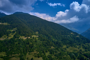 Fototapeta na wymiar Panoramic view of the Ponte di Legno region of Trento the north of Italy. The popular ski resort town of Ponte di Legno. Summer time of the year. Aerial view. Photo taken on a drone.