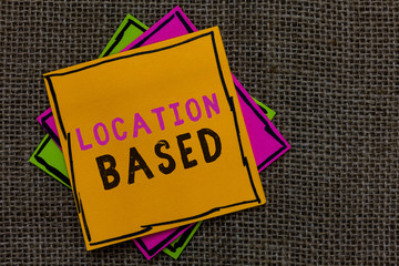 Text sign showing Location Based. Conceptual photo Mobile marketing to target users within same geographic area Paper notes Important reminders Communicate ideas messages Jute background