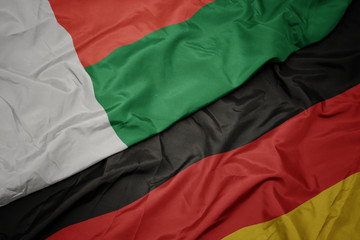 waving colorful flag of germany and national flag of madagascar.