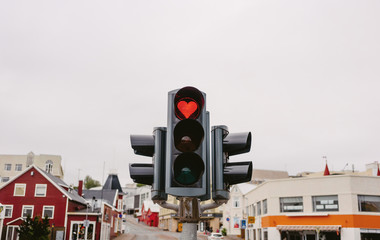 A traffic lights with red hearth in Akureyri city. Iceland. Sign of love