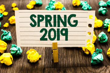 Fototapeta premium Text sign showing Spring 2019. Conceptual photo time of year where flowers rise following winter season Clothespin holding notebook paper crumpled papers several tries mistakes