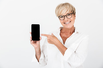 Portrait of happy adult woman with short blond hair holding cellphone and showing black screen