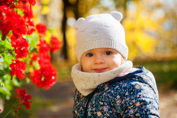 little girl and red flowers