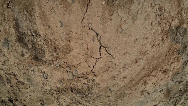 Cracking earth. Swelling and breaking. Dry soil with sand.