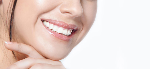 Womanl with a beautiful smile and healthy teeth on a white background close-up