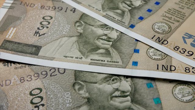 Close up shot of rotating Indian currency 500 rupee notes. 