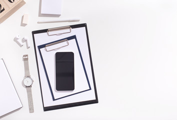 Cellphone with blank space and office supplies on white