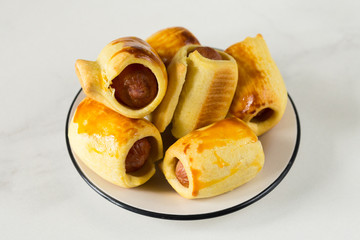 Pastry wrapped sausage rolls, fried sausage pies in dough. Junk food