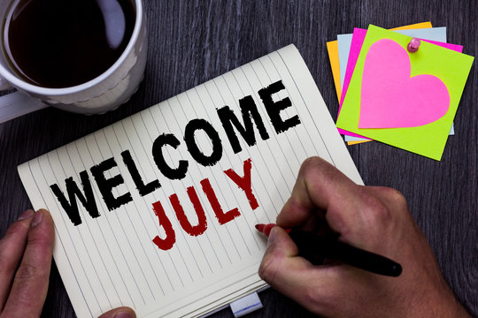 Conceptual hand writing showing Welcome July. Business photo text Calendar Seventh Month 31days Third Quarter New Season Man holding marker giving ideas wooden table cup coffee hearts
