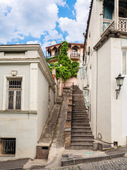 Fototapeta na wymiar Stairs between two old buildings in historical part of Tbilisi