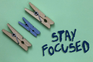 Conceptual hand writing showing Stay Focused. Business photo showcasing Be attentive Concentrate Prioritize the task Avoid distractions Three brown blue vintage clear background Holding things