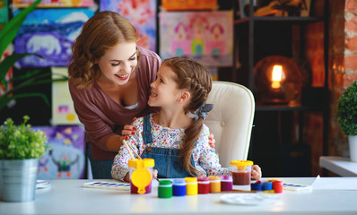 mother and child daughter painting draws in creativity in kindergarten.
