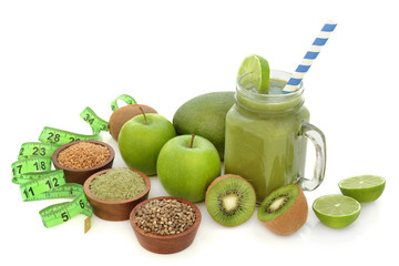 Healthy fruit juice smoothie drink with tape measure and dietary food supplement powders of matcha, flax and hemp seed on white background. High in omega 3, antioxidants, vitamins and dietary fibre.