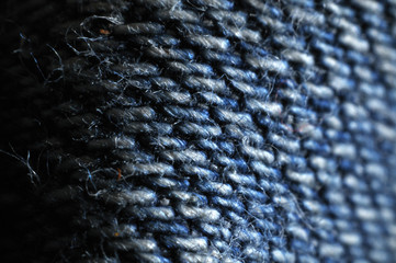 close-up of denim fabric of old blue jeans