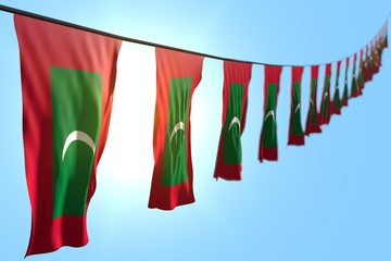 beautiful any celebration flag 3d illustration. - many Maldives flags or banners hanging diagonal on rope on blue sky background with selective focus