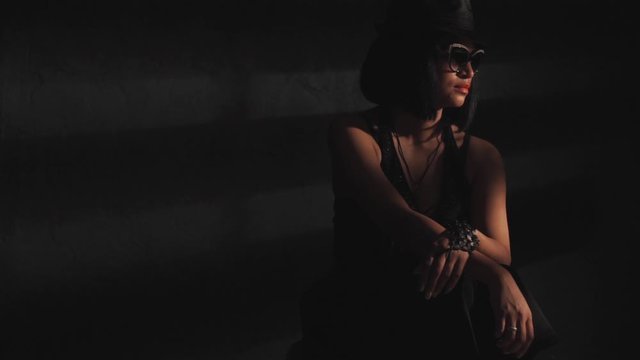 Woman in hat and glasses in the light