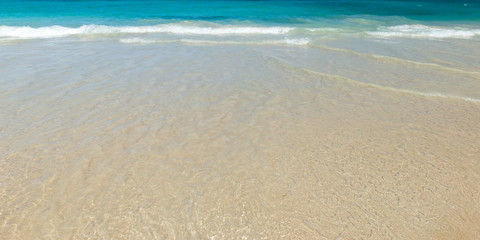 Fototapeta na wymiar The texture of the sea wave on the sand