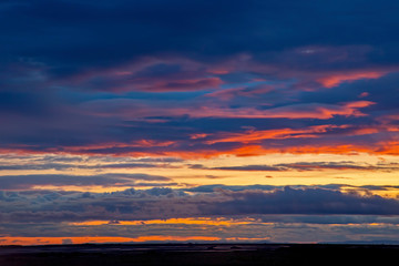 Unrealistic colorful sunset in the lush clouds in Iceland