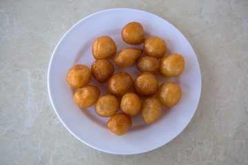 Traditional Turkish Lokma Sweet, fried sweet dough covered in a syrup and served