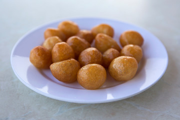 Traditional Turkish Lokma Sweet, fried sweet dough covered in a syrup and served