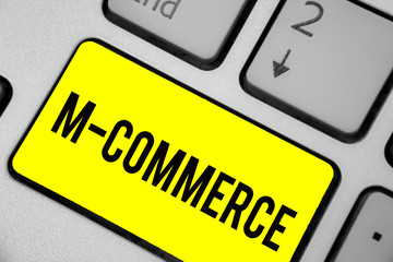 Word writing text M Commerce. Business concept for commercial transactions conducted electronically by mobile phone Keyboard yellow key Intention create computer computing reflection document