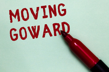 Handwriting text Moving Goward. Concept meaning Towards a Point Move on Going Ahead Further Advance Progress Open red marker intention communicating message ideas green background