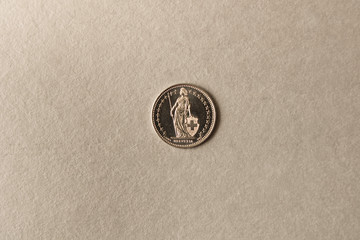 Silver coin on grey background. Close up.