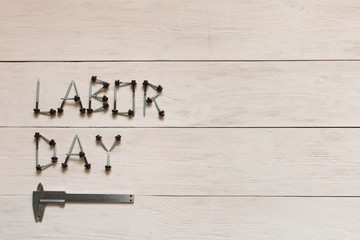 Labor day. Inscription labor day on a light wooden background.