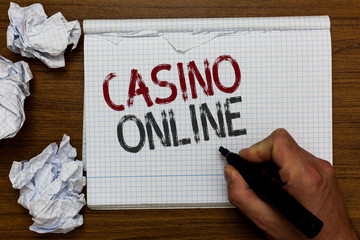 Handwriting text Casino Online. Concept meaning Computer Poker Game Gamble Royal Bet Lotto High Stakes Man holding marker notebook crumpled papers ripped pages mistakes made