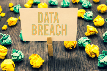 Fototapeta premium Handwriting text writing Data Breach. Concept meaning security incident where sensitive protected information copied Clothespin holding light pink note paper crumpled papers several tries