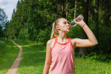 female jogger quenches thirst