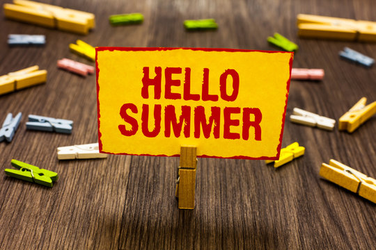 Text sign showing Hello Summer. Conceptual photo Welcoming the warmest season of the year comes after spring Clothespin holding yellow paper note several clothespins wooden floor