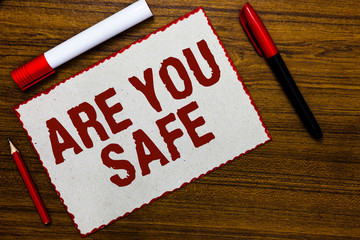 Handwriting text writing Are You Safe. Concept meaning Free from danger Not anticipating any Harm Hurt physically White paper red borders markers wooden background communicating ideas