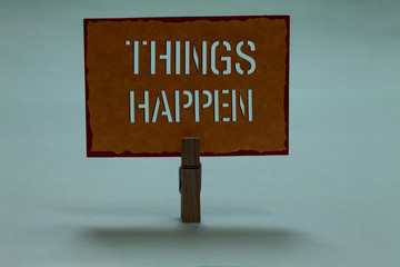 Text sign showing Things Happen. Conceptual photo Result of situation Course of action Something cannot control Clothespin holding orange paper important communicating message ideas