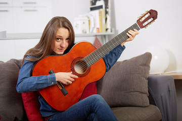 woman play guitar at home