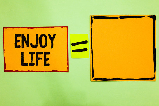 Writing note showing Enjoy Life. Business photo showcasing Any thing, place,food or person, that makes you relax and happy Orange paper notes reminders equal sign important messages to remember